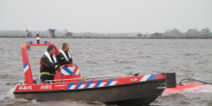 Catamaran slaat om door harde wind op Schildmeer