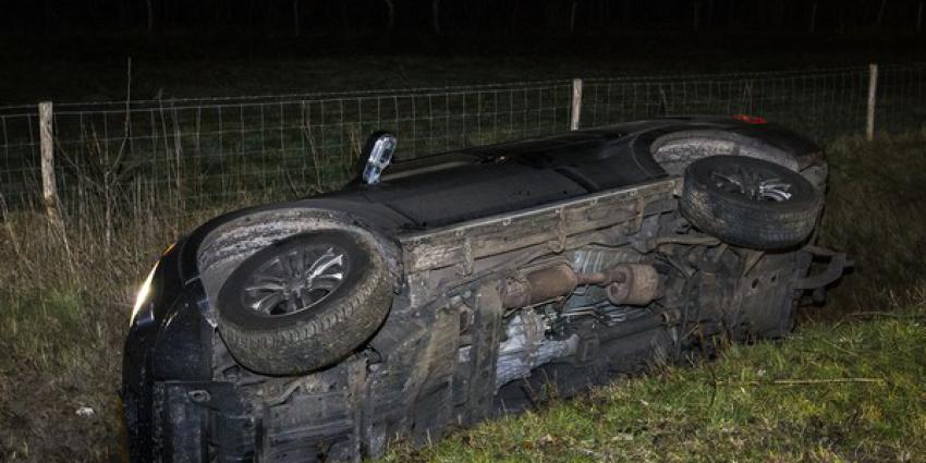 Jeep ramt lantaarnpaal en belandt op zijn kant in sloot 