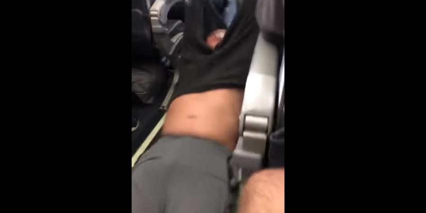 United Airlines sleept passagier door gangpad