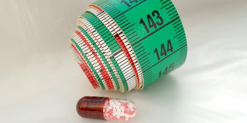 Foto van meetlint en pil