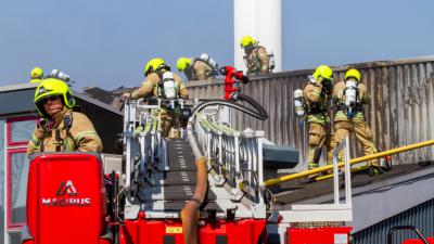 Foto van brandweerlieden op ladderwagen