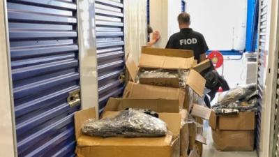 Foto van medewerker FIOD en namaak kleding