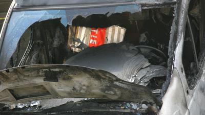 Foto van uitgebrand politiebusje | Archief EHF